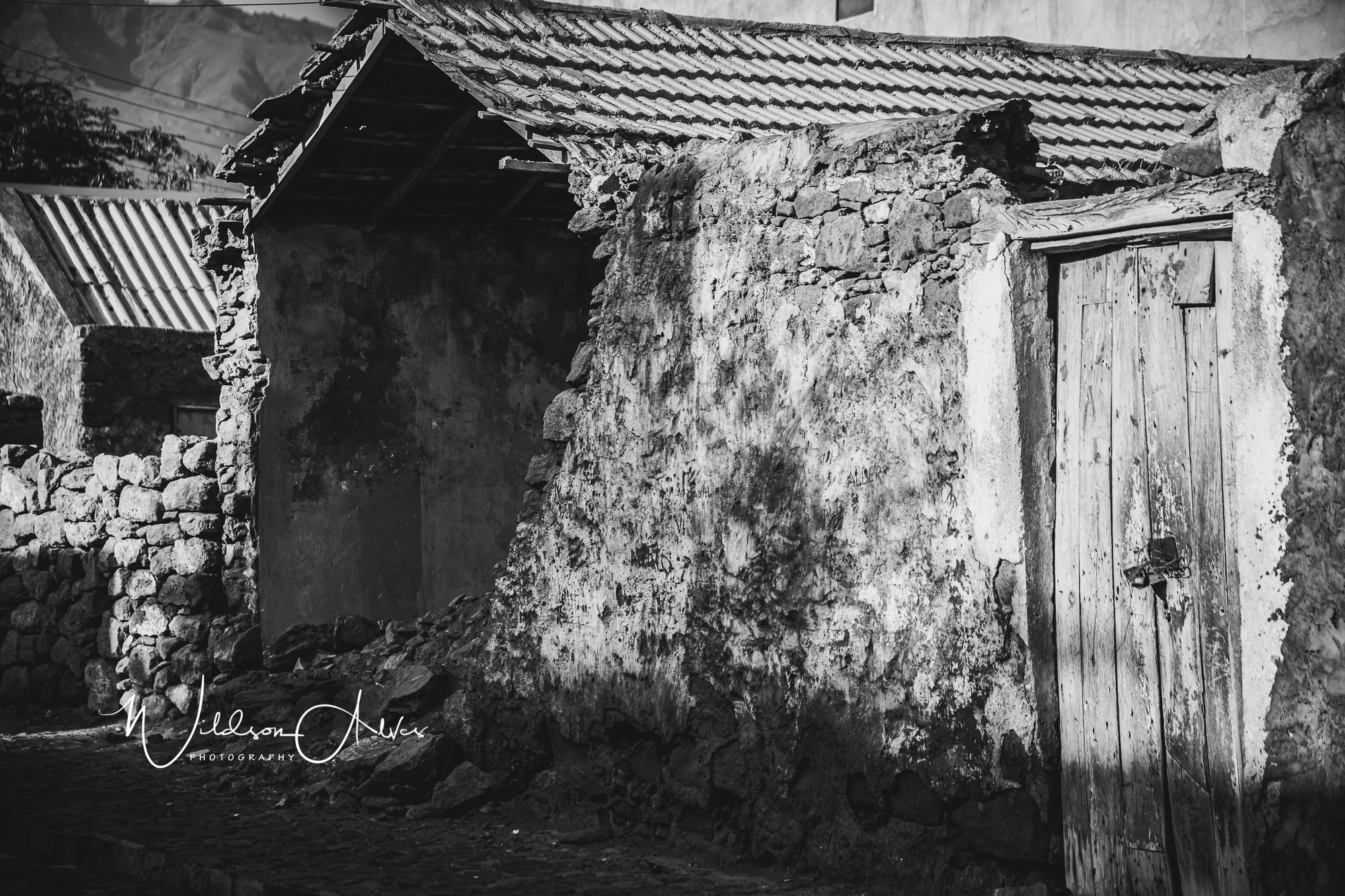Détail d’un mur de pierre et d’une porte en bois ancienne